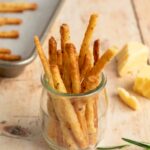 cheese straws in jar on table.