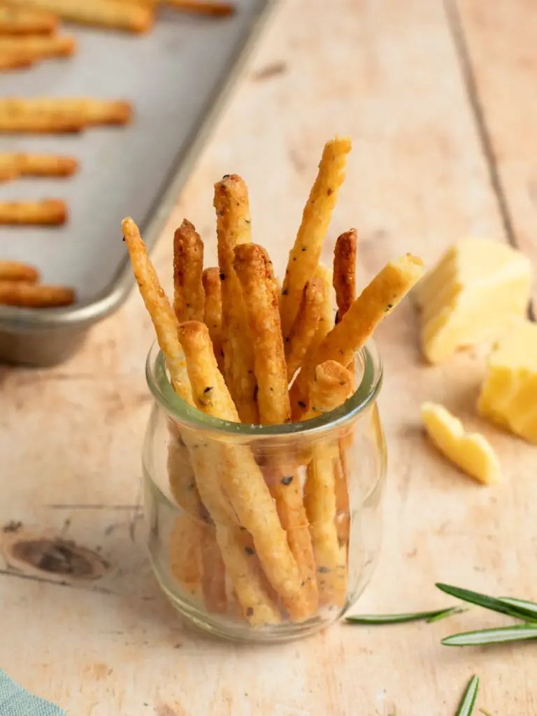 cheese straws in jar on table.