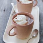 2 mugs of hot chocolate with whipped cream