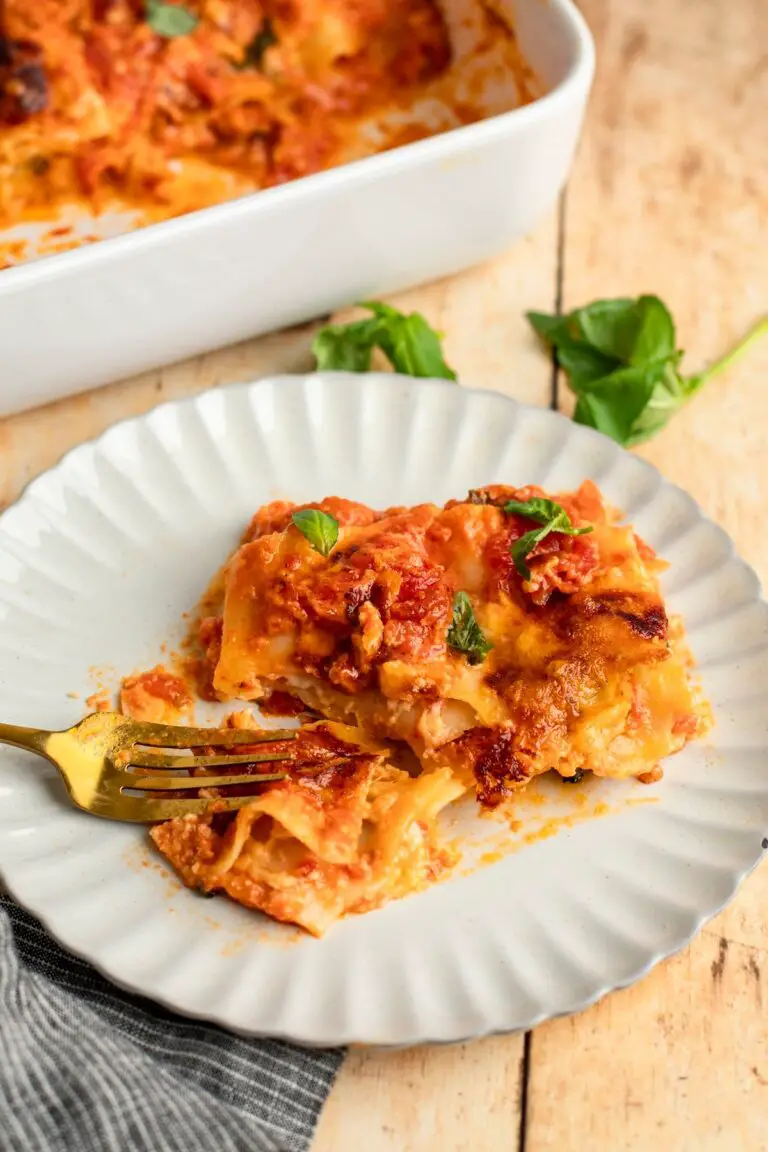 Slice of cheese lasagna on plate.