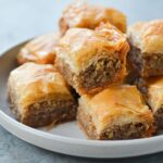 Baklava piled on a plate.