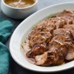 Serving tray of mustard-glazed pork tenderloin.