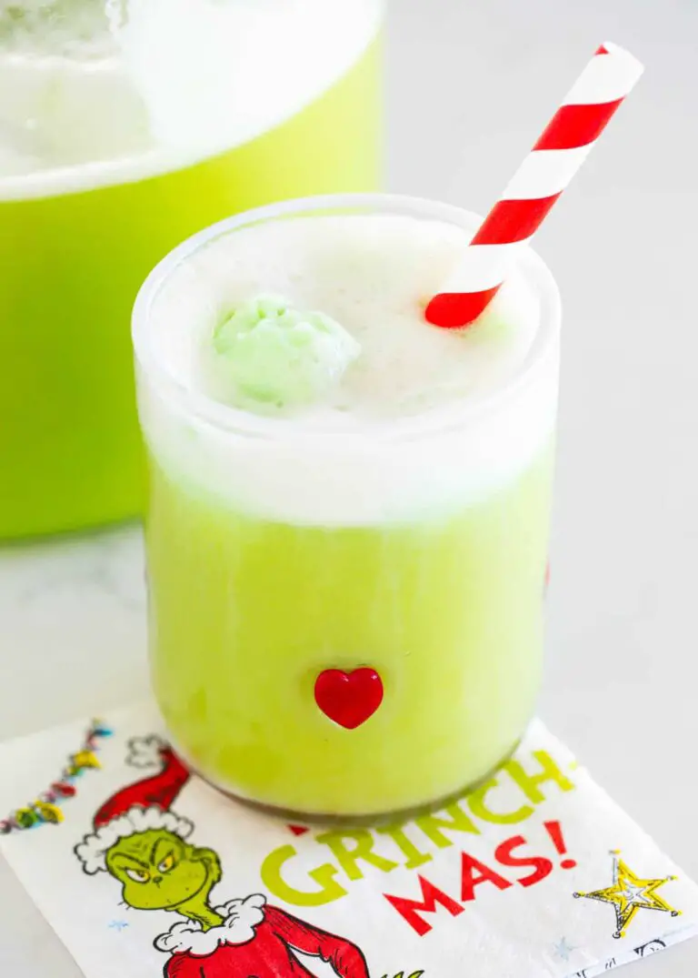 Grinch punch in a glass cup.