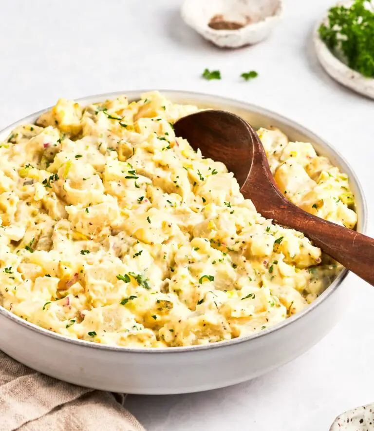 bowl of potato salad with wooden spoon