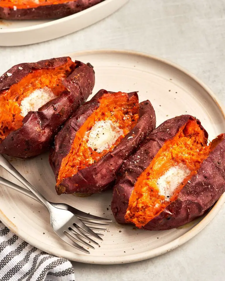 baked sweet potatoes with butter on platter with dish towel