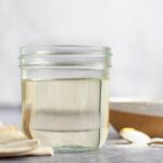 jar of simple syrup with spoon and linen napkin