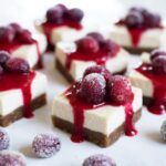 slices of No-Bake Christmas Cheesecake Bars with cranberries